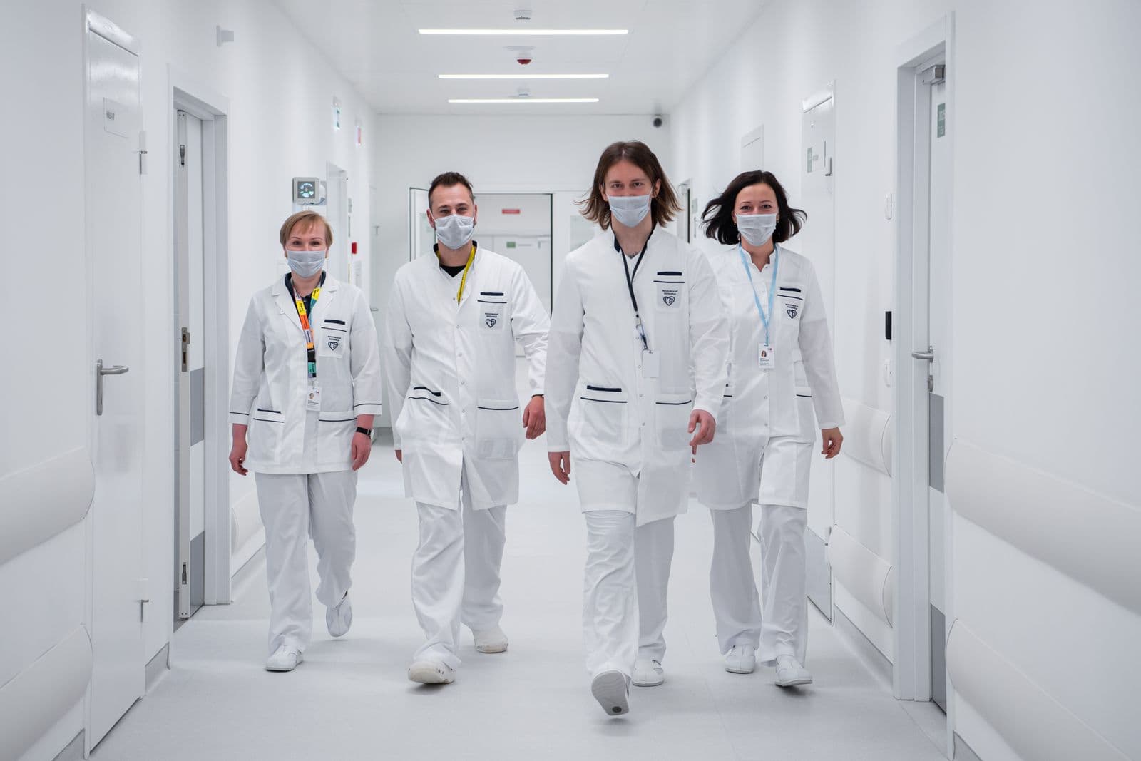 Medical team walking through a bright modern hospital corridor